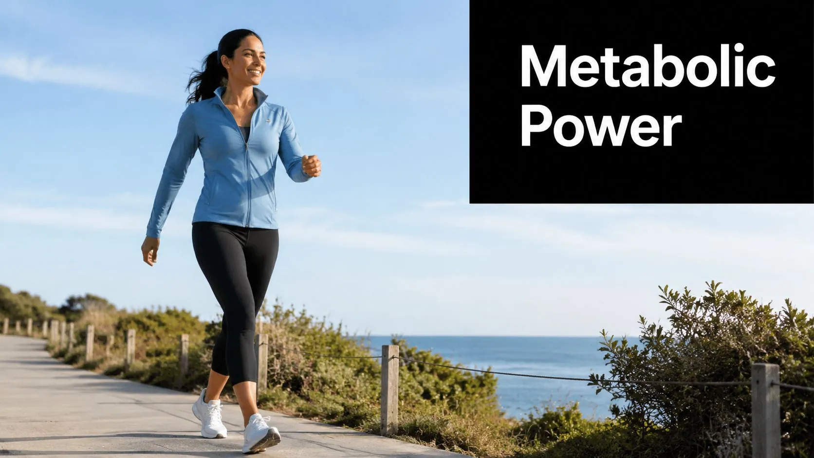 A fit woman walking confidently along a coastal path on a sunny day for metabolic exercise.