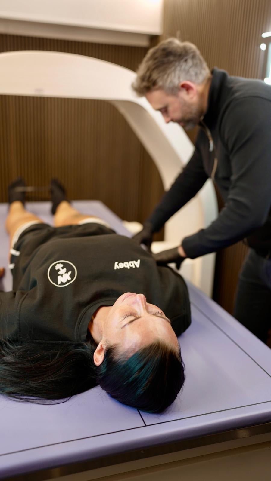 A woman being prepared for a Telomyx DEXA body composition scan